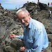 Professor Chris Wilson using the knife on a Specialist Group of Tectonics and Structural Geology field trip at Cape Liptrap, Victoria.