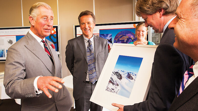 Prince Charles receives a photograph from Antarctic Division Director Dr Tony Fleming.