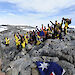 The Mawson’s Huts centenary team pose for a photograph on Proclamation Hill on 16 January 2012. The stainless steel time capsule in the foreground, which contains a message from the Prime Minister and other objects and messages relevant to today’s Antarctic program, will be opened in 2112.