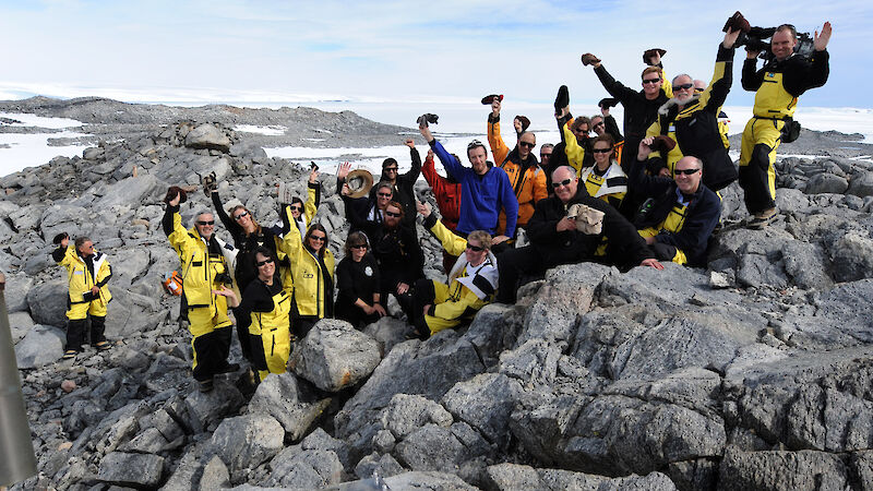 The Mawson’s Huts centenary team pose for a photograph on Proclamation Hill on 16 January 2012. The stainless steel time capsule in the foreground, which contains a message from the Prime Minister and other objects and messages relevant to today’s Antarctic program, will be opened in 2112.