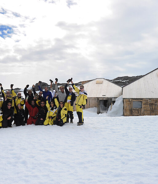 The Mawson’s Huts centenary team pose for a photograph in front of the huts.