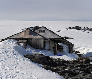 View of the main living hut and workshop at Cape Denison today, from a snow drift above.