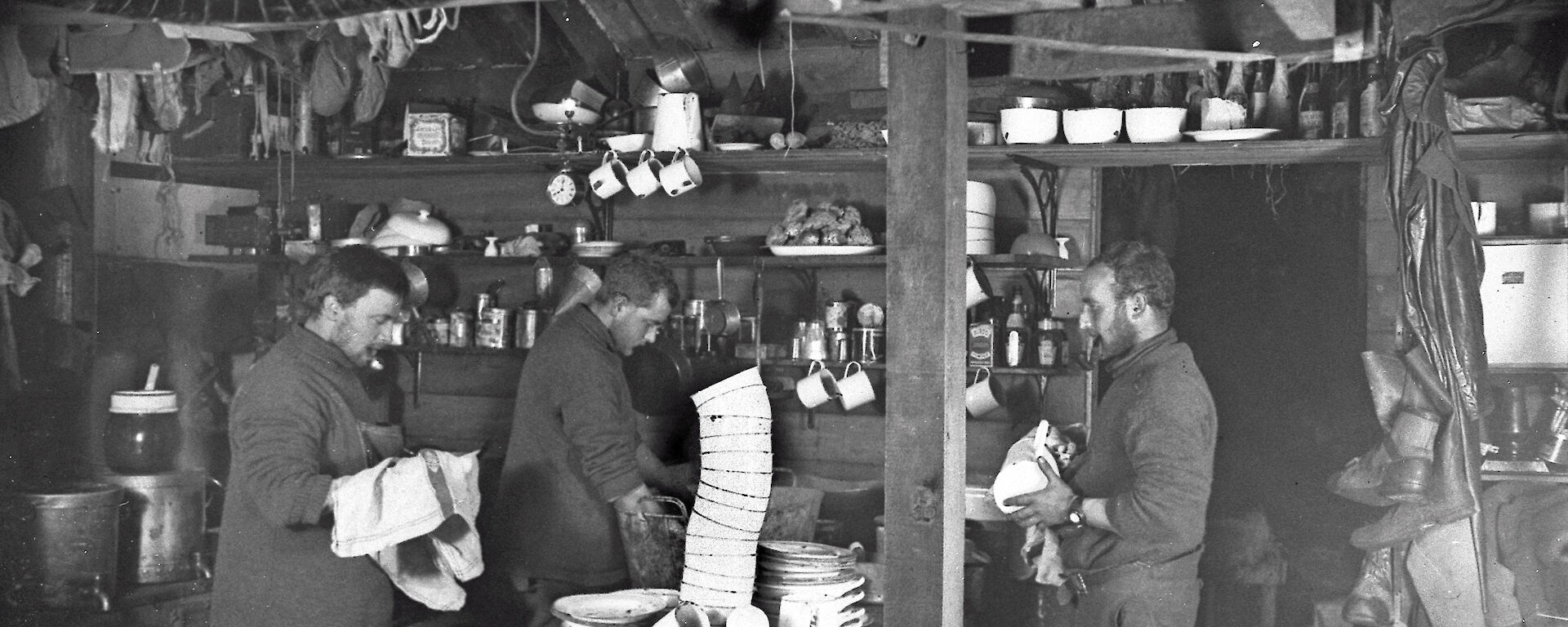 John Hunter (left), Alfred Hodgeman and ‘Robert’ Bage wash up in the living quarters of the Main Hut, 1912.