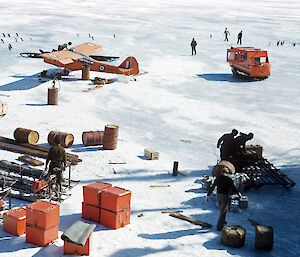 Supplies from Kista Dan being unloaded, including a barge caravan (top right) and the Auster 200 (top left) which was later destroyed in a storm