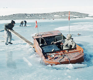 Phillip Law attempts to rescue a Weasel from the sea ice at Mawson, 1954