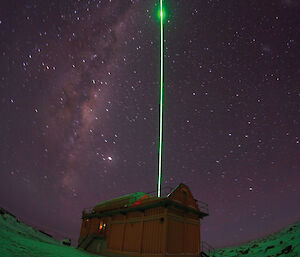 The Davis LIDAR with its green laser light in the night sky.