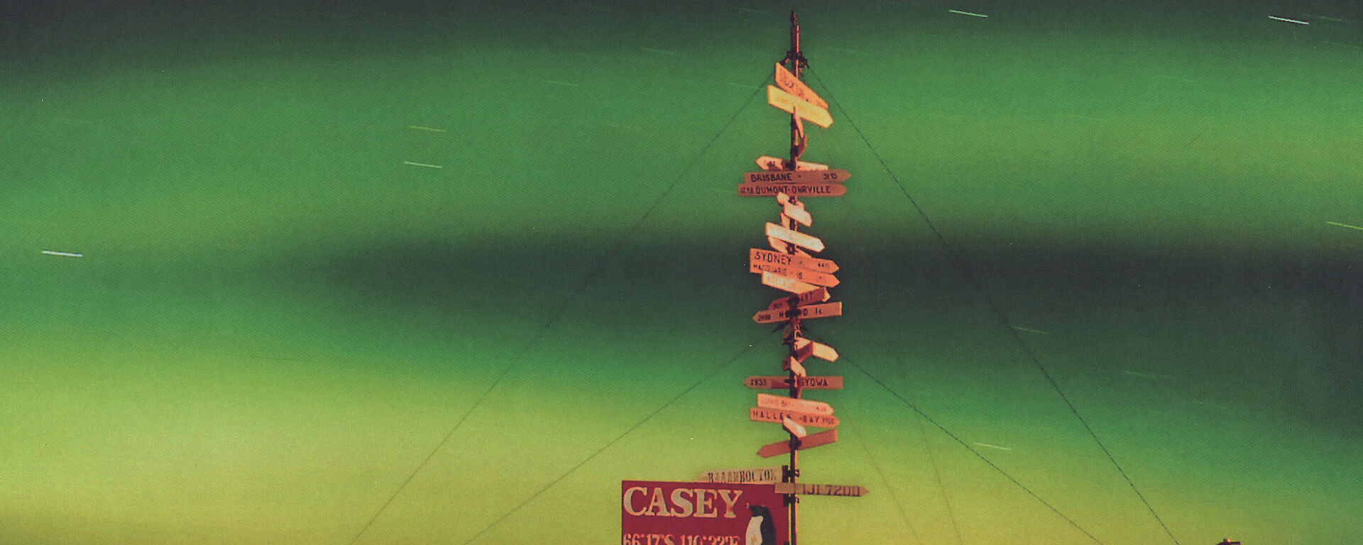 The Casey station 2010 yearbook cover with a colour photo of the aurora and the Casey station sign.