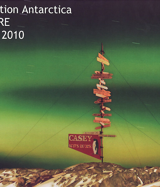 The Casey station 2010 yearbook cover with a colour photo of the aurora and the Casey station sign.