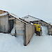 David Ellyard stands outside Mawson’s Main Hut, surrounded by snow and ice.