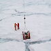 Scientists collect an ice core on an ice floe.