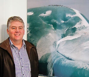 Steve with one of his award-winning photographs of a jade iceberg, at an exhibition at Parliament House, Canberra, in 2007.