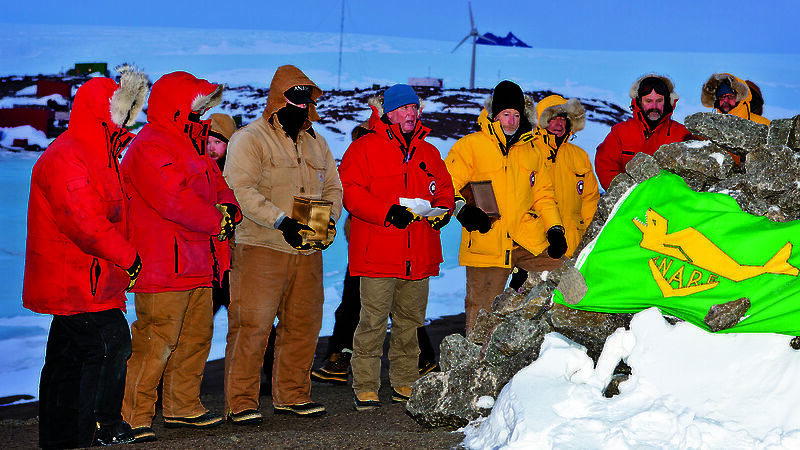 Station Leader Mark Williams conducts the interment ceremony flanked by Mawson expeditioners carrying the ashes of Phil and Nel Law, and the remaining 2011 wintering expedition team.