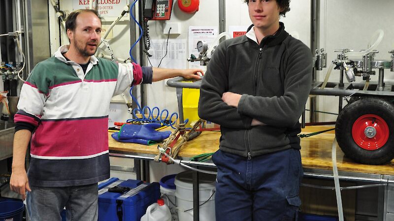 Tim Williams (left) and David Wilkins in the Aurora Australis laboratory preparing to filter water samples