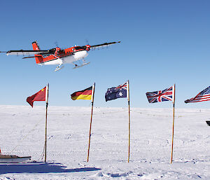 A Twin Otter flies over the flags of countries participating in Antarctica’s Gamburtsev Province project. Such scientific collaboration today is the result of the Antarctic Treaty system.
