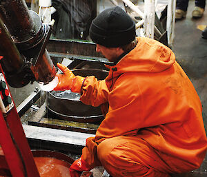 A scientist removes an ice core from the drill rig at Vostok.