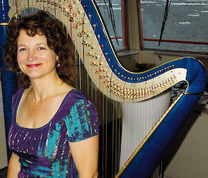 Alice with her electro-acoustic harp on the bridge of the Aurora Australis.