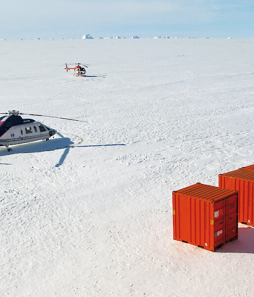 The Sikorsky S76 (left) and Squirrel helicopters during the Mawson resupply from the sea ice.