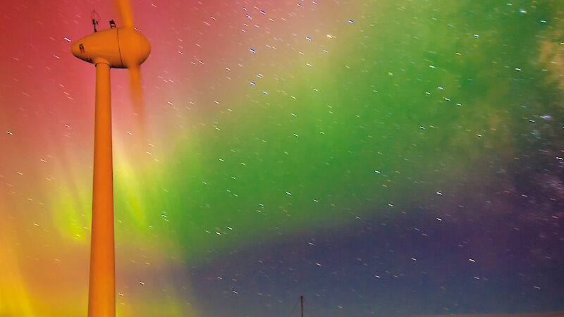 An aurora behind the wind turbine at Mawson.