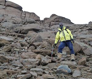 Expeditioner on rocky slope on the side of Mt. Henderson