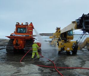 Using fire hoses to wash a crane