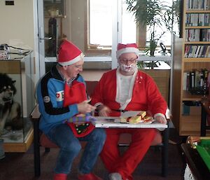 Santa and helper distribute gifts