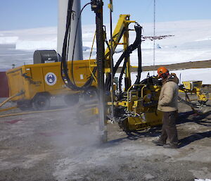 Drilling into rock to install anchor rods