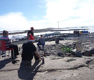 Expditioners enjoy a drink in the afternoon sun in the new garden