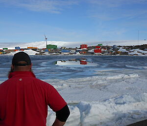 A view across the open pool of water in Horseshoe Harbour with the station in the background