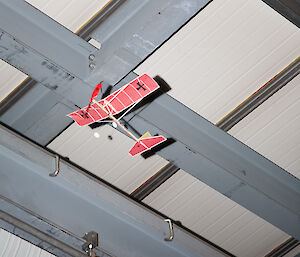 Model aircraft flying very close to building roof