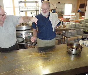 Chef and assistant spinning out lines of very hot caramelised sugar