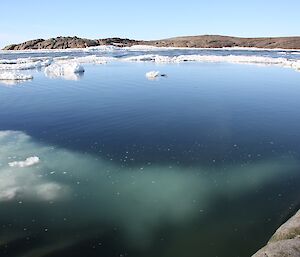 Open water off the tip of Beche with ice underwater in foreground