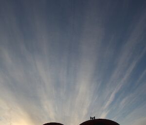 Huts at Beche against the late evening light and a spectacular cloud scape