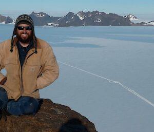 Clint at top of Fang Peak, with ranges behind Rumdoodle in the distance