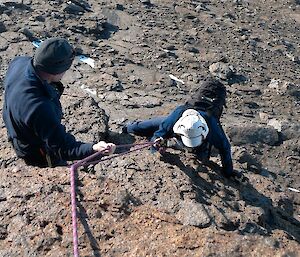 Expeditioners using ropes for safety whilst climbing Fang Peak