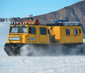 Using a Hägglunds with a drag beam to spread out snow across the runway