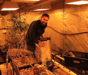 Expeditioner Clint cleans out a tray in the hydroponics facility
