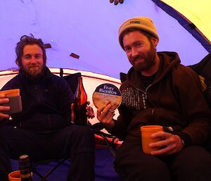 Expeditioners in the field enjoy Christmas breakfast — tinned steak and kidney pie and cold drinks