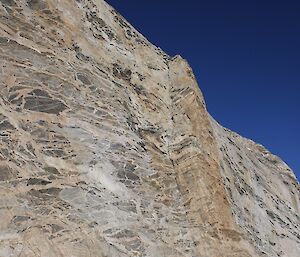 Massive rock face at Turk Glacier camp site — people are minute by comprison