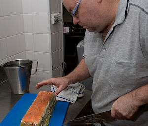 Chef slicing the salmon terrine into serve sized pieces
