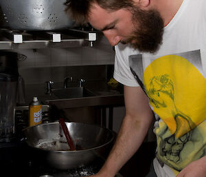 Expeditioner Clint preparing the chocolate fondant in moulds