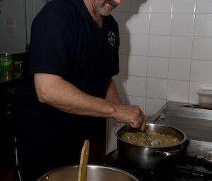 Expeditioner Rodney looks after the pots on the stove