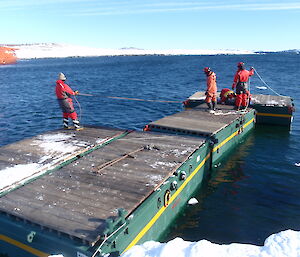 Getting the unifloats together to bring the big crane in