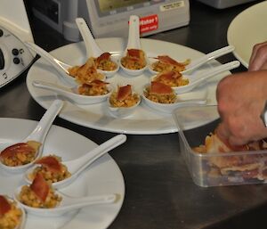 Chefs special canapes for saturday night dinner served on spoons