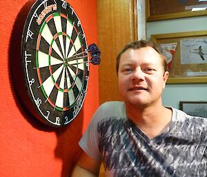 pete showing off his triple bull on the darts board