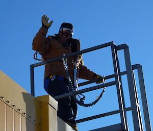 Anders waves to the photographer from the top of the yellow Operations building.