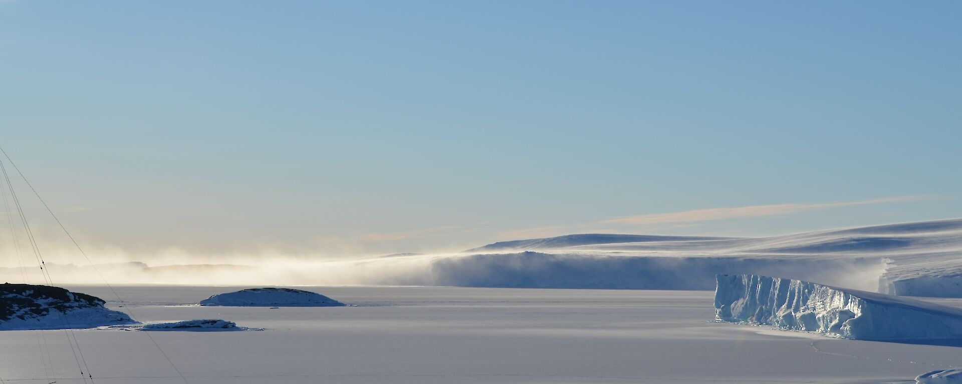 Snow blowing off the ice cliffs to the east of station