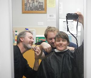 Two of the station hairdressers both cutting the hair of our Deputy Station Leader