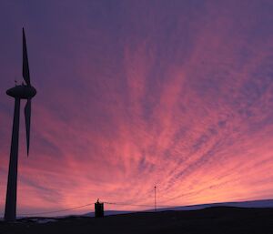 Sunrise over East Bay with clouds radiating from the sun over wind turbine number 2