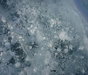 Magnificent ice formation, showing all types of patterns in the refrozen melt lake.