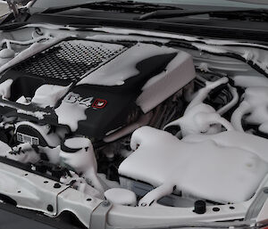 Engine bay of hilux with blown snow covering everything